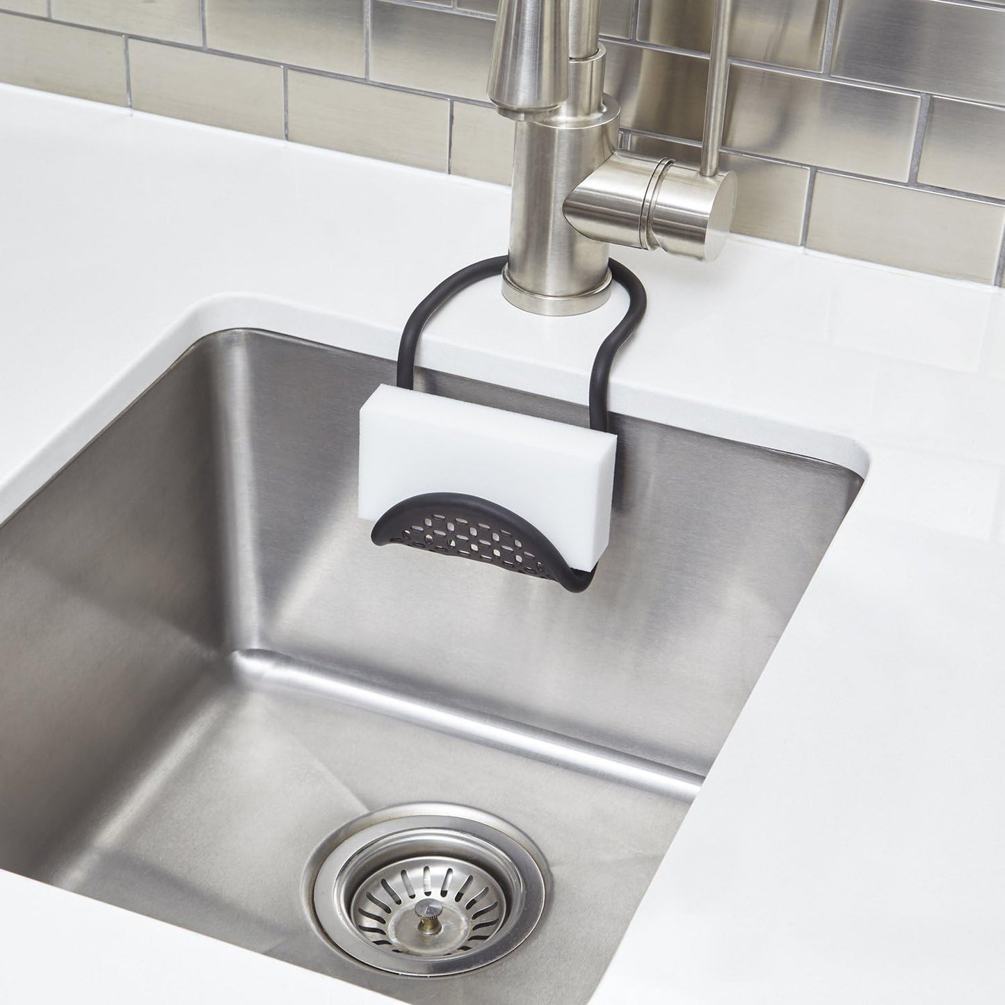 Sling Flexible Sink Caddy, Elastic Non-Slip Sponge Holder, Black | Rubber material, perforated base for drainage, prevents moisture buildup, fits faucet necks, easy rinse clean